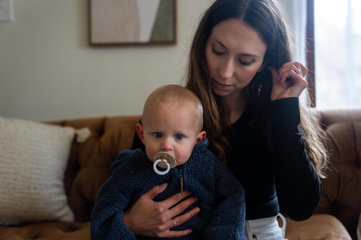 Emily Donlin holds her 9-month-old son, Paul, Tuesday, Dec. 5, 2023, in Des Moines. After Paul's birth, the umbilical cord was screened in a nonconsensual drug test, which came back positive for cocaine. The family claims the test results were a false positive.