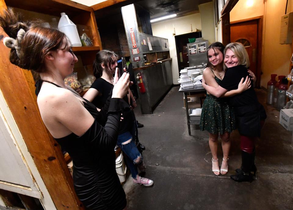 Madison Holson takes a picture of Hope McBee with Jessica Esfandiary, daughter of owners Ali and Patty on the last night of business for the Fort Griffin General Merchandise and Beehive Saloon on Jan. 28. The girls, students at Albany High School, dropped by the restaurant where they've worked since the summer, having come from their winter formal dance.