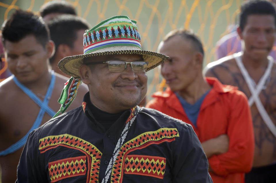 In this Nov. 26, 2018 photo, an Ngabe-Bugle indigenous man wearing his traditional dress waits for his turn in the bow and arrow competition, on the second edition of the Panamanian indigenous games in Piriati, Panama. These games drew athletes who will represent Panama in the third edition of the World Indigenous Peoples Games. (AP Photo/Arnulfo Franco)