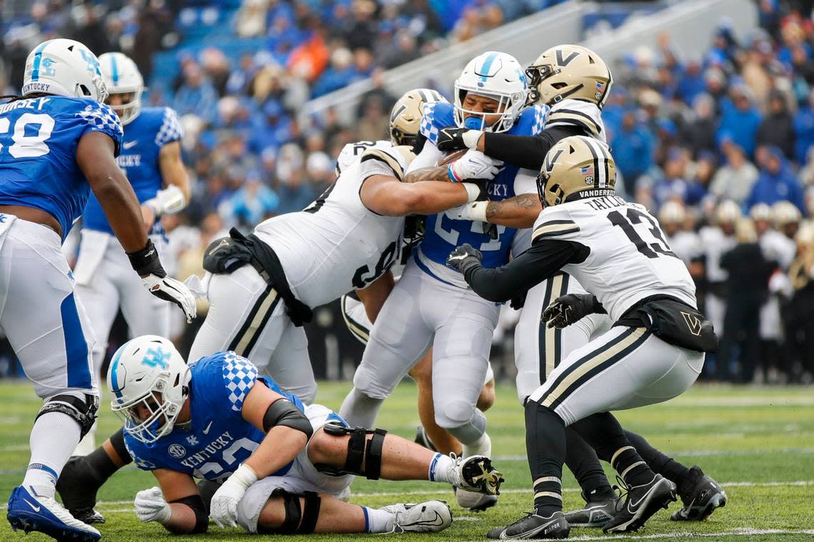 Kentucky Wildcats running back Chris Rodriguez Jr. (24) is tackled by multiple Vanderbilt Commodores defenders during the game Kroger Field in Lexington, Ky., Saturday, November 12, 2022.