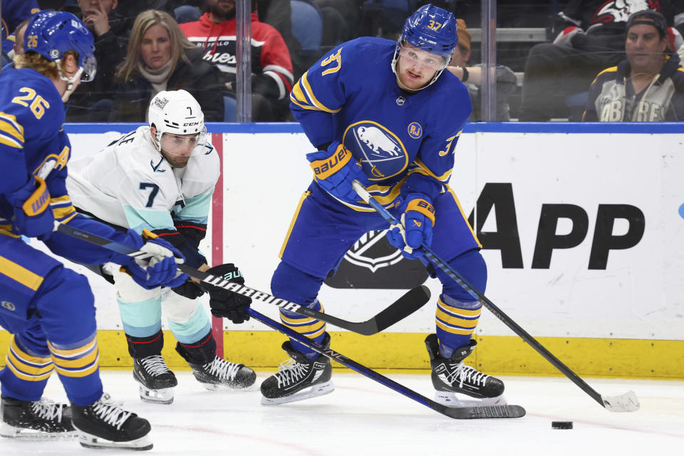 Buffalo Sabres center Casey Mittelstadt (37) is pressured by Seattle Kraken right wing Jordan Eberle (7) during the second period of an NHL hockey game Tuesday, Jan. 9, 2024, in Buffalo, N.Y. (AP Photo/Jeffrey T. Barnes)