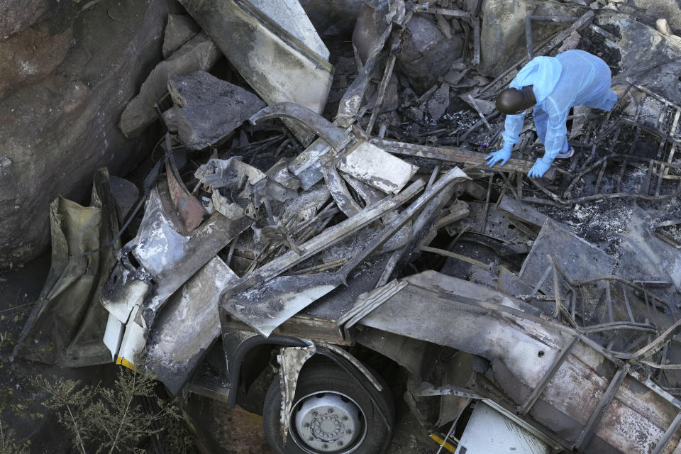 The wreckage off a bus lays in a ravine a day after it plunged off a bridge on the Mmamatlakala mountain pass between Mokopane and Marken, around 300km (190 miles) north of Johannesburg, South Africa, Friday, March 29, 2024. A bus carrying worshippers on a long-distance trip from Botswana to an Easter weekend church gathering in South Africa plunged off a bridge on a mountain pass Thursday and burst into flames as it hit the rocky ground below, killing at least 45 people, authorities said. The only survivor was an 8-year-old child who was receiving medical attention for serious injuries. (AP Photo/Themba Hadebe)