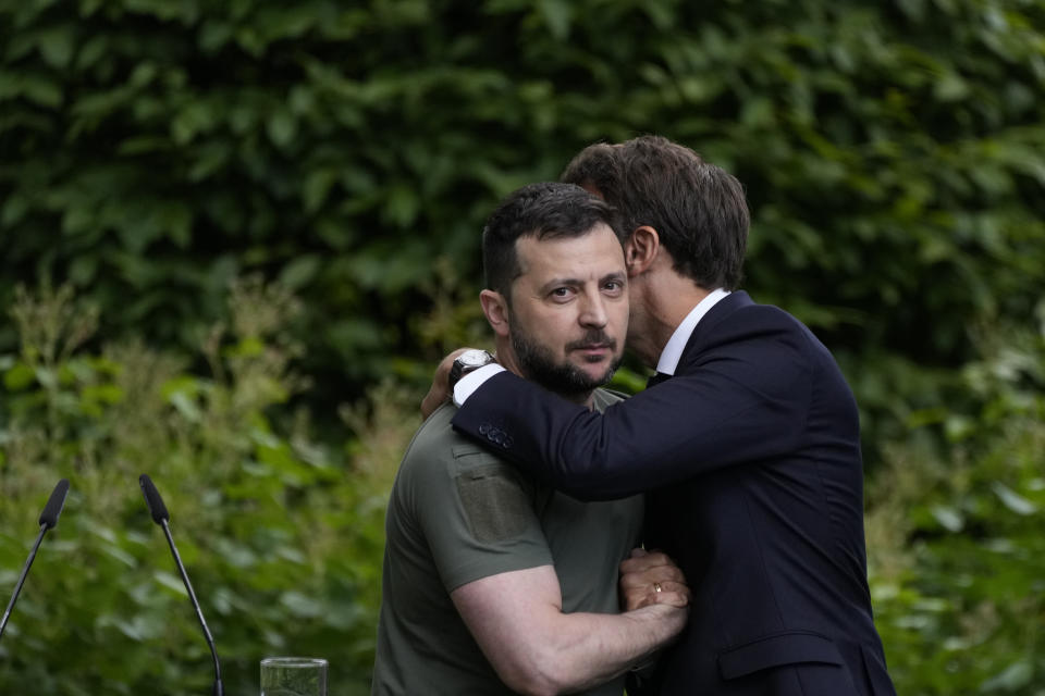 FILE - Ukraine President Volodymyr Zelenskyy, left, embraces France's President Emmanuel Macron at the end of a conference at the Mariyinsky palace in Kyiv, Ukraine, June 16, 2022. Emmanuel Macron is hosting Tuesday Dec. 13, 2022, in Paris an international conference meant to help Ukraine make it through winter. On the longer term, he insists talks with Russia will be needed to find a path to peace. (AP Photo/Natacha Pisarenko, File)