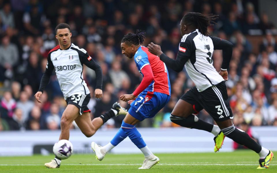 Michael Olise of Crystal Palace shoots under pressure from Calvin Bassey
