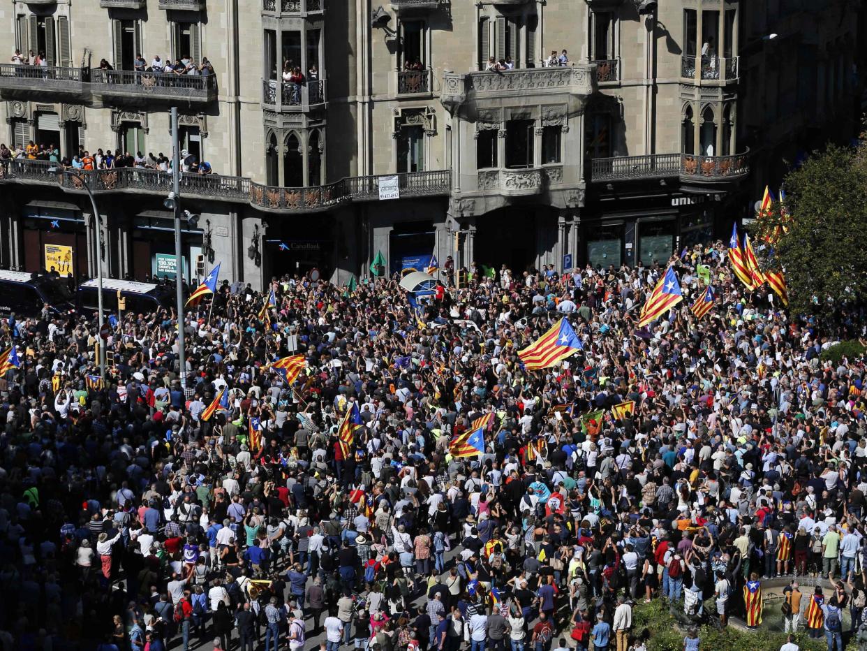 People holding 'Esteladas' (Catalan pro-independence flags) attend a protest near the Economy headquarters of Catalonia's regional government in Barcelona: Pau Barrena/AFP