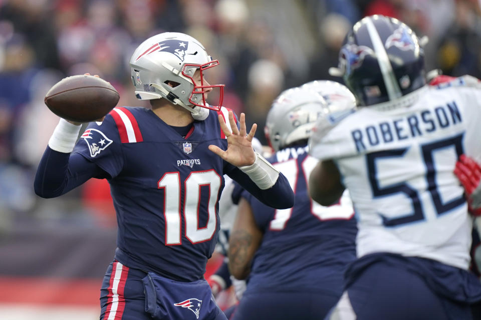 New England Patriots quarterback Mac Jones (10) passes under pressure during the first half of an NFL football game against the Tennessee Titans, Sunday, Nov. 28, 2021, in Foxborough, Mass. (AP Photo/Steven Senne)
