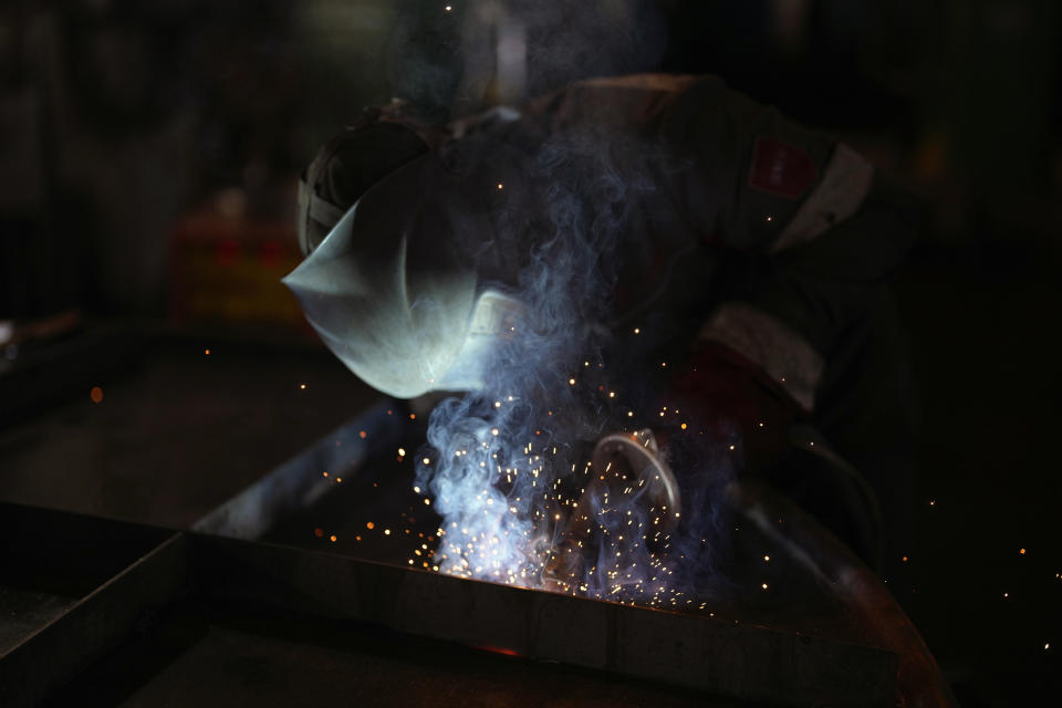 A worker welds a shelter in a plant of Metinvest company, in Kryvyi Rih, Ukraine, Thursday, March 2, 2023. The plant, which is part of Renat Akhmetov's Metinvest metals and mining holding, ships metal shelters to frontline. (AP Photo/Thibault Camus)