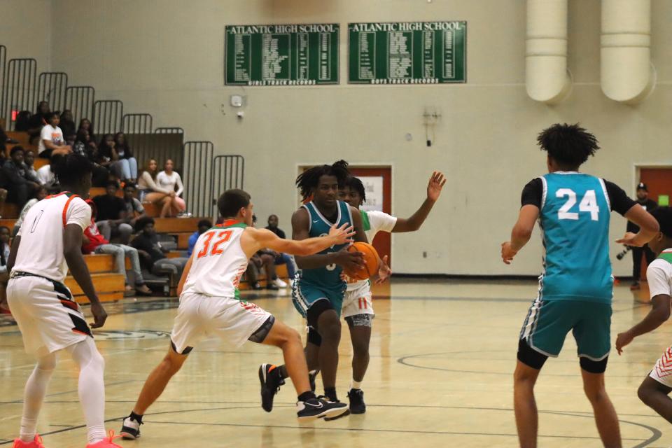 Atlantic junior Lincoln Graf looks to get in front of Royal Palm Beach and top scoeee of the night Jayden Coney. The Wildcats defeated Atlantic, 73-66, in a tight season opener at Atlantic High on November 22, 2023.