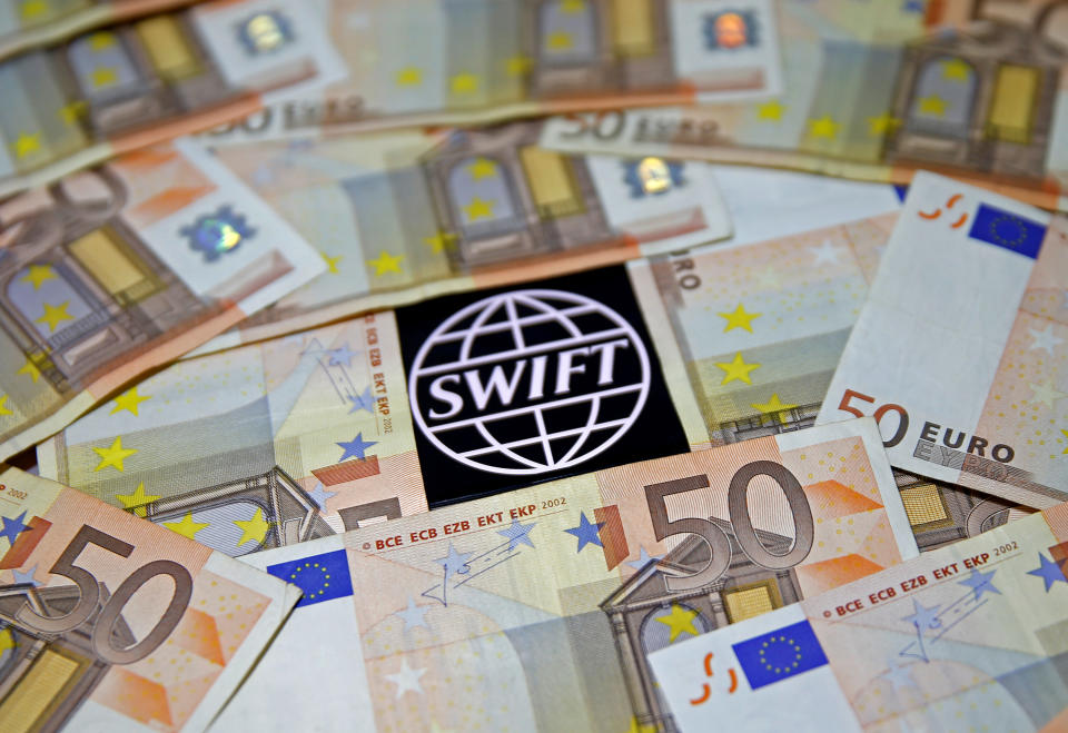 Swift code bank logo is displayed among Euro banknotes 