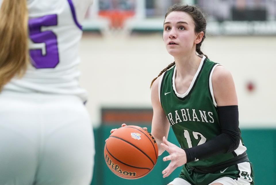 Pendleton Heights Arabians guard Kaycie Warfel (12) searches to pass the ball Wednesday, Jan. 31, 2024, during the game at Pendleton Heights High School in Pendleton.