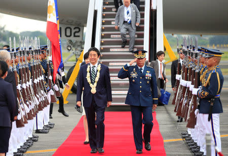 Japanese Prime Minister Shinzo Abe review honour guards upon arrival for a state visit in metro Manila, Philippines January 12, 2017. REUTERS/Romeo Ranoco