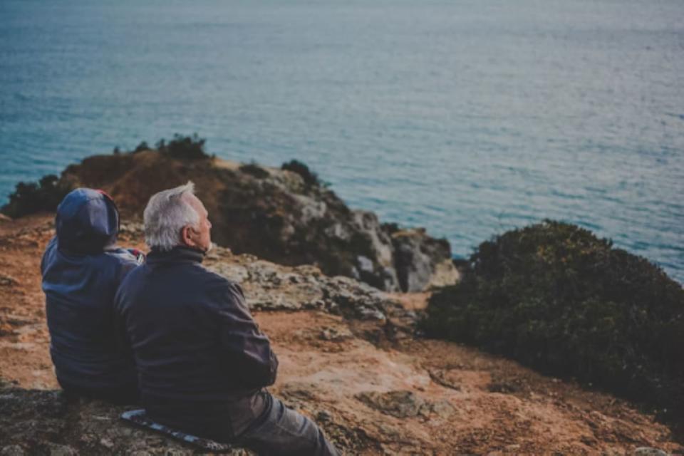 Elderly couple sitting by the sea