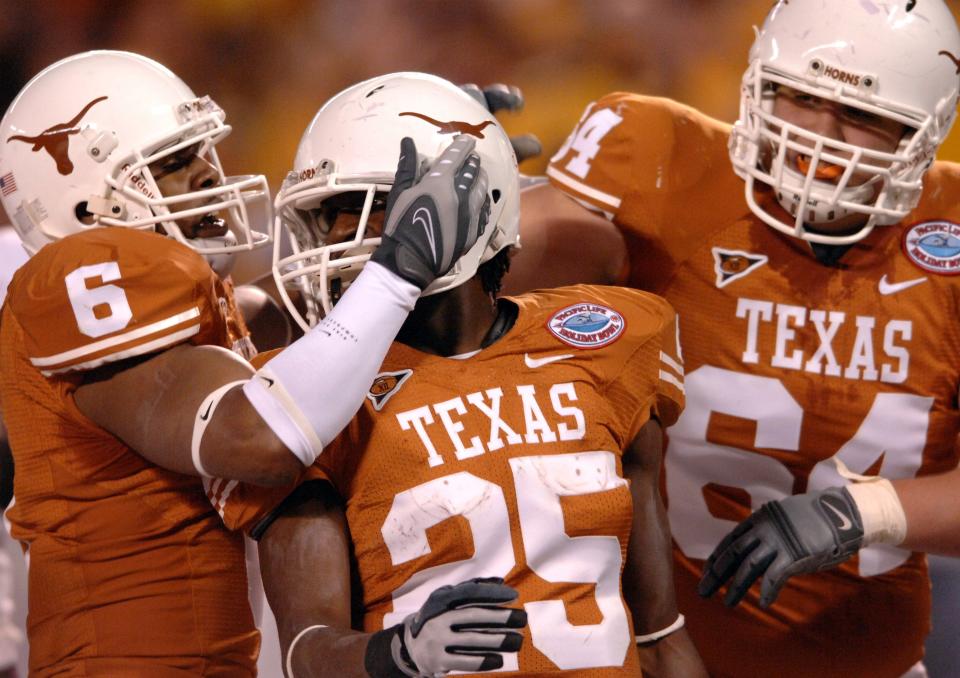 Texas running back Jamaal Charles celebrates with wide receiver Quan Cosby and offensive lineman Kyle Hix after scoring a 15-yard touchdown run against Arizona State in the 2007 Holiday Bowl. Charles left school early after that season for the NFL and was drafted in the third round by the Kansas City Chiefs.