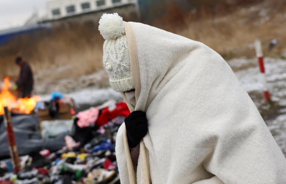 A woman wrapped in a blanket at the border checkpoint in Medyka, Poland.