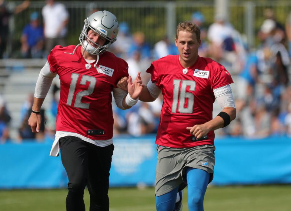 Detroit Lions quarterbacks Tim Boyle and Jared Goff run after training camp Saturday, July 31, 2021 at the Allen Park facility.