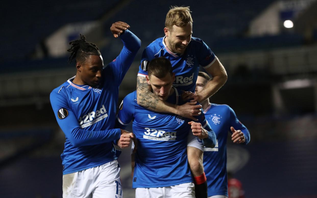 Borna Barisic of Rangers celebrates after scoring their team's fourth goal from the penalty spot with Ryan Kent of Rangers and Scott Arfield of Rangers - Getty Images
