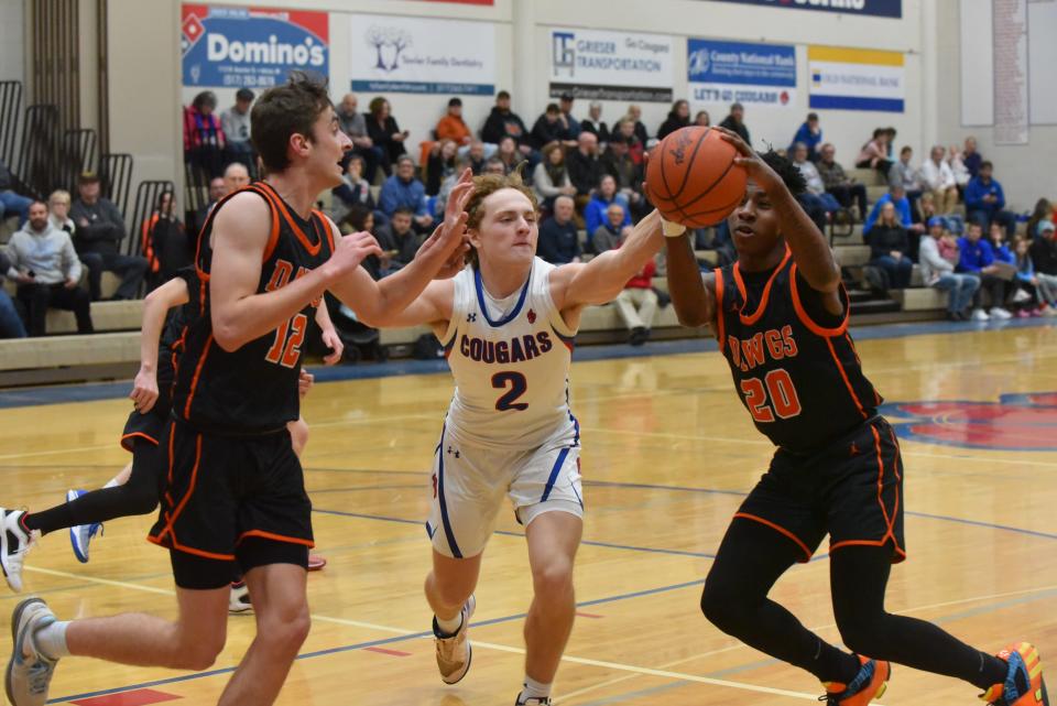 Tyler Dafoe (left) and Jha Jha Hornbeak of Summerfield chase a loose ball with Jesse Miller of Lenawee Christian Tuesday night. Summerfield fell 69-62.