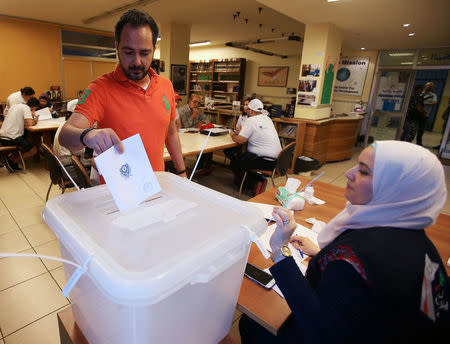 A man casts his vote at a polling station during the parliamentary election, in Sidon, Lebanon May 6, 2018. REUTERS/Ali Hashisho