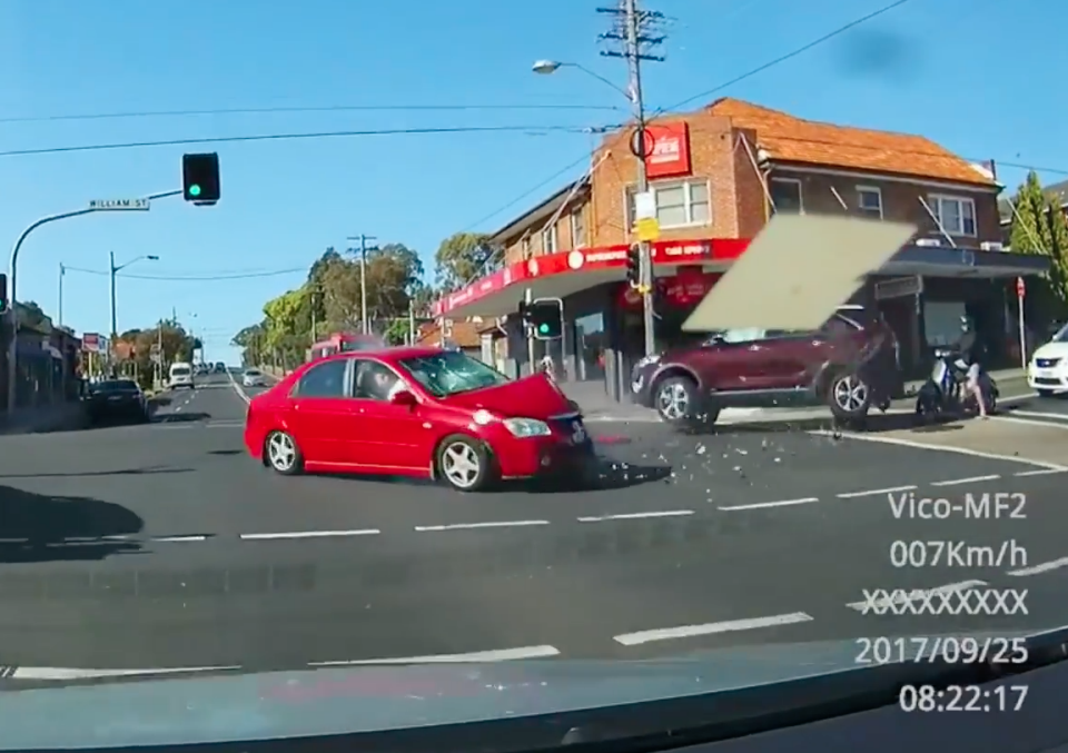 The Kia narrowly missed a Vespa driver waiting at the intersection. Photo: Facebook