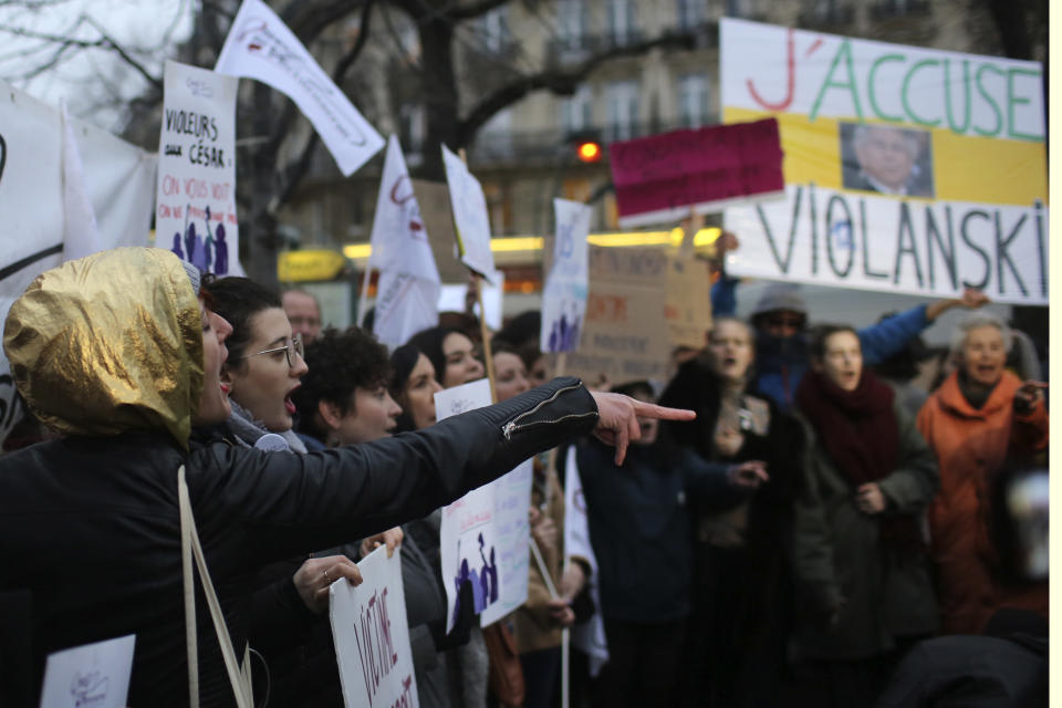 Women demonstrate outside the venue of the Cesar awards ceremony, the French equivalent of the Oscar, Friday,Feb. 28, 2020 in Paris. French women's rights activists protest against multiple nominations for Roman Polanski at the Cesar Awards ceremony. Poster at right reads "I accuse Violanski", playing withe French word for rape and the name Polanski. (AP Photo/Rafael Yaghobzadeh)