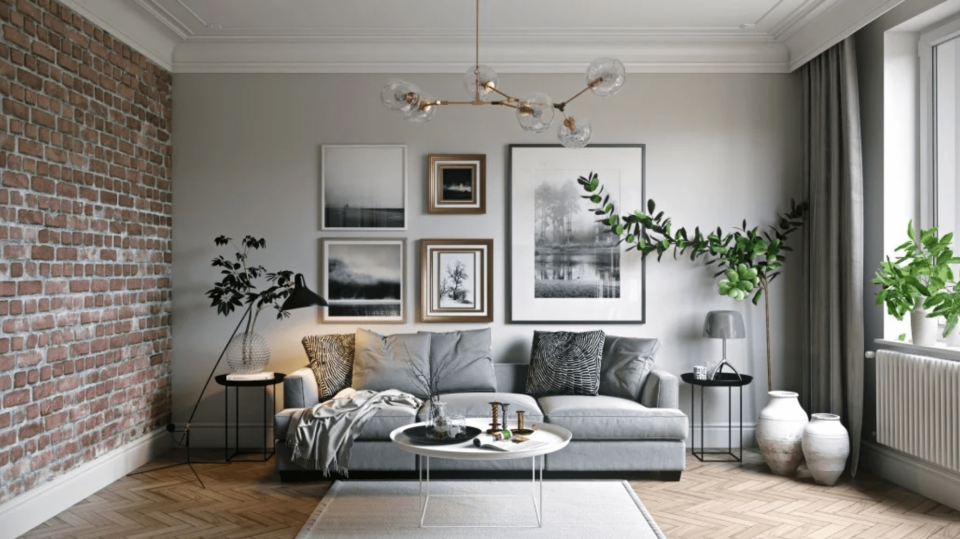 This modern living room incorporates rougher materials like brick and geometric lighting fixtures for a classic 20th-century look.