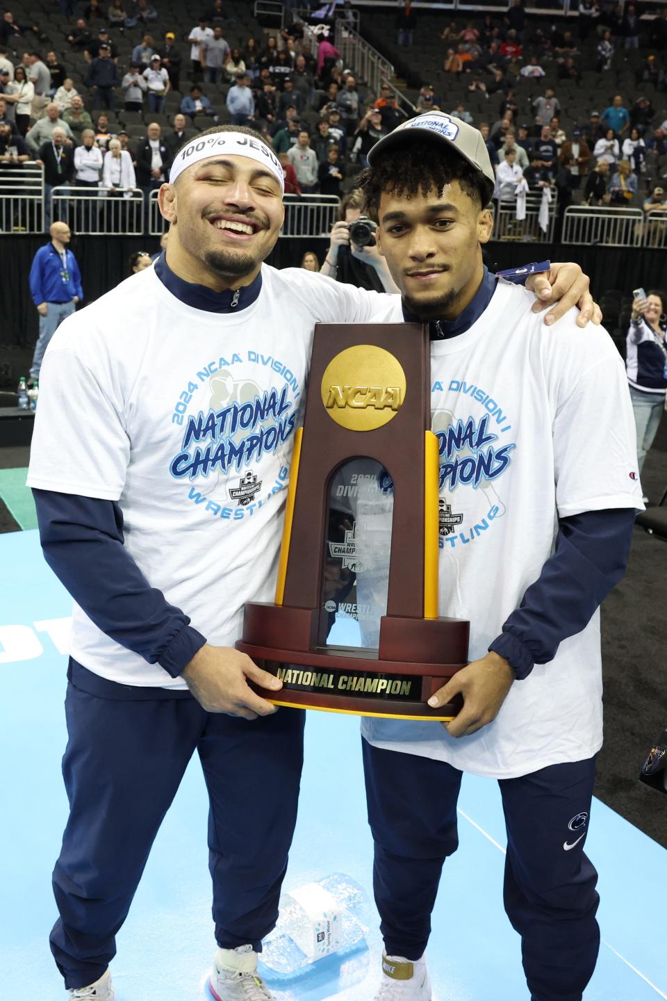 Mar 23, 2024; Kansas City, MO, USA; 174 pound Penn State Nittany Lions wrestler Carter Starocci and 197 pound Penn State Nittany Lions wrestler Aaron Brooks pose with the Championship trophy after winning their fourth National Title at the T-Mobile Center. Mandatory Credit: Reese Strickland-USA TODAY Sports