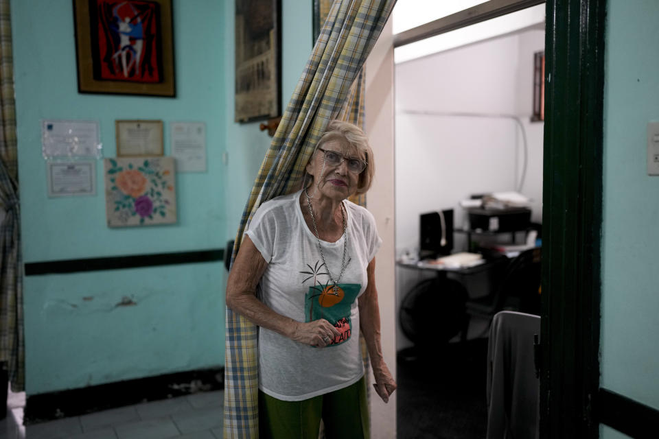 Betty Santucci, 85-year-old president of the Caballito and Villa Crespo, a recreational day center for retirees, poses for a portrait in Buenos Aires, Argentina, Wednesday, April 12, 2023. Santucci said that retirees can no longer afford to go out for coffee or meet for lunch to celebrate birthdays, and instead stay for free coffee at the retirement center after group activities. (AP Photo/Natacha Pisarenko)