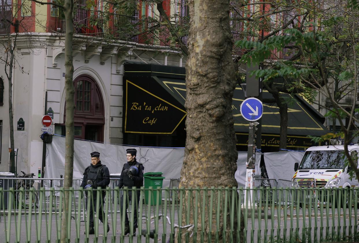 Police officers walk outside the Bataclan concert hall, Saturday, Nov. 14, 2015 in Paris. 