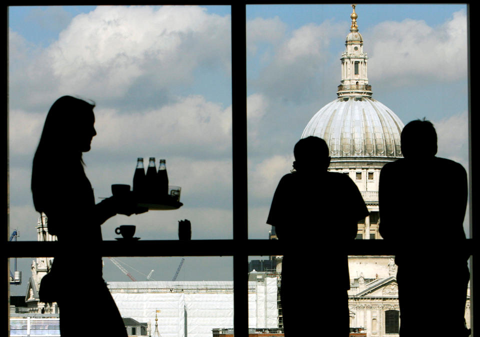 Services sector: Visitors admire St. Paul's Cathedral from the Tate Modern gallery in London