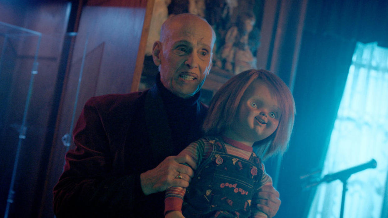  John Waters as Wendell Wilkins holding a Good Guys doll in Chucky Season 3. 