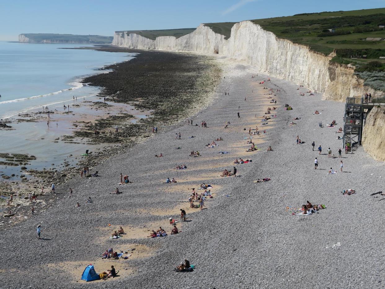 People enjoy the good weather on a beach near Eastbourne, Sussex, on 20 May, 2020: Mike Hewitt/Getty Images