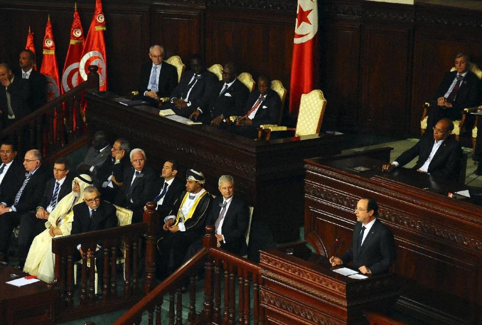 French President Francois Hollande, center right, delivers his speech at the Constituent Assembly in Tunis, Friday, Feb.7, 2014. Hollande and other world leaders attended a ceremony for the formal adoption of a document being praised as one of the most progressive constitutions in an Arab nation. (AP Photo/Hassene Dridi)