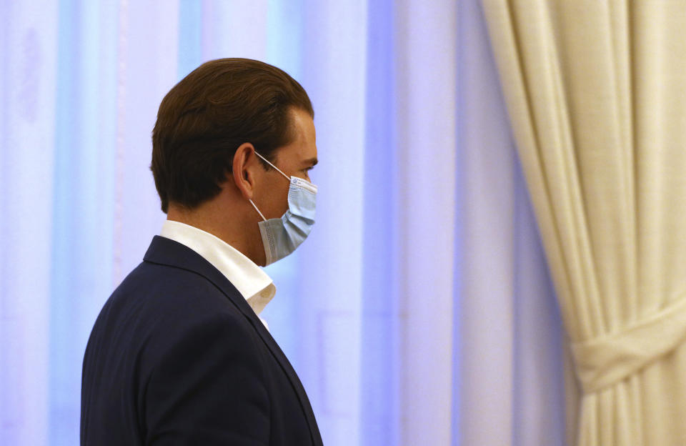 Austrian Chancellor Sebastian Kurz with a face mask walks at the federal chancellery in Vienna, Austria, Saturday, Oct. 31, 2020. The Austrian government has moved to restrict freedom of movement for people, in an effort to slow the onset of the COVID-19 coronavirus. (AP Photo/Ronald Zak)