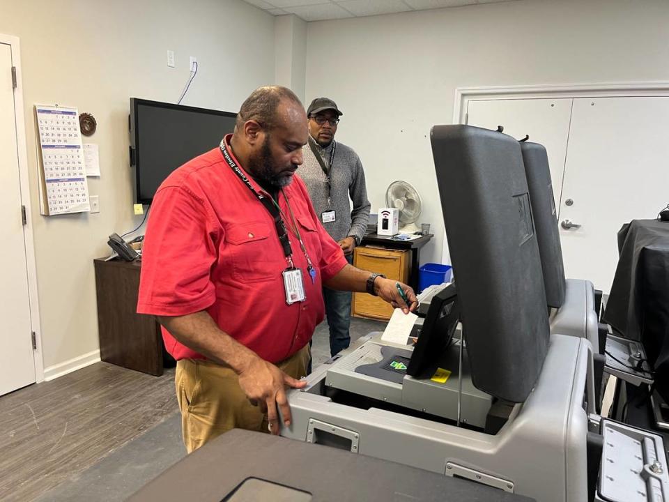 Vernon Kemp, IT election system coordinator, prints results from the Beaufort mayoral race at the Beaufort County Board of Voter Registration and Elections office Tuesday evening as Mychael Gibbs, assistant IT elections system specialist, looks on.