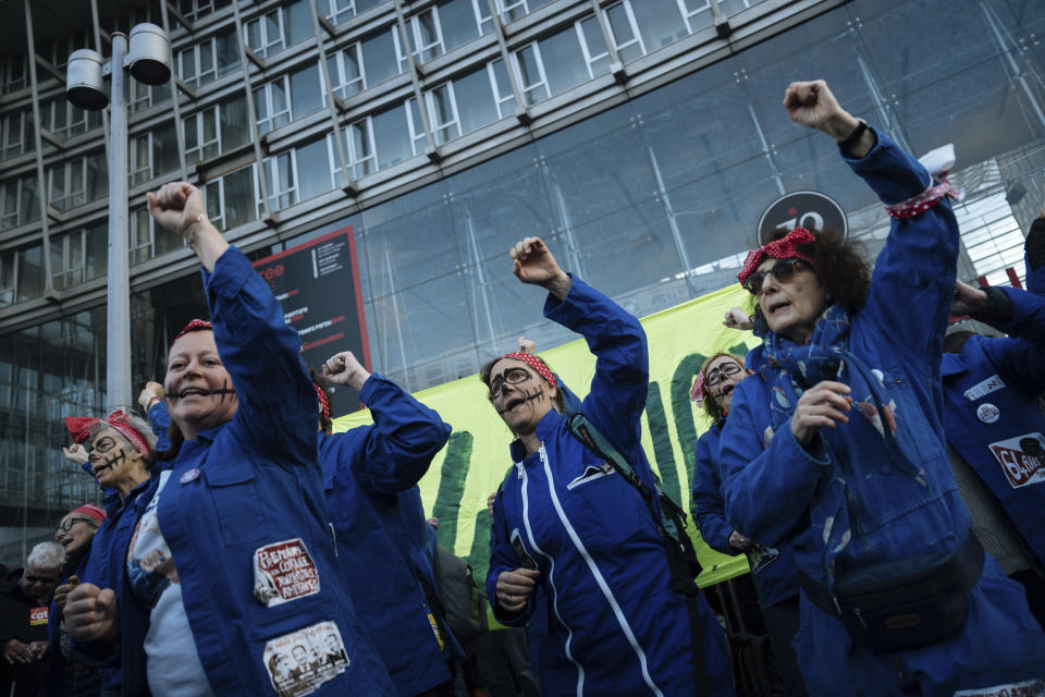 Protesters dance during a protest in Paris, Saturday, March 18, 2023. A spattering of protests were planned to continue in France over the weekend against President Macron's controversial pension reform, as garbage continued to reek in the streets of Paris and beyond owing to continuing action by refuse collectors. (AP Photo/Lewis Joly)