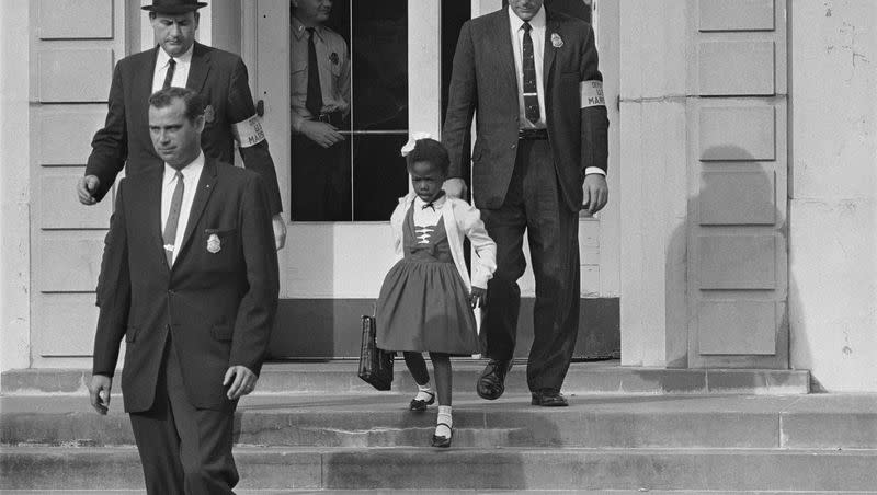 U.S. Deputy Marshals escort 6-year-old Ruby Bridges from William Frantz Elementary School in New Orleans, La., in November 1960. The first grader was the only Black child enrolled in the school, where parents of white students boycotted the court-ordered integration law.
