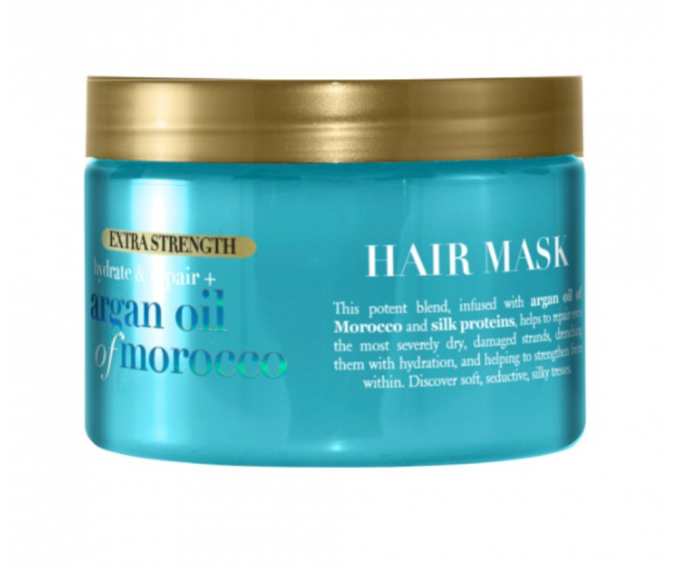 A blue tub of OGX Extra Strength Argan Oil Hair Mask witg a gold lid.