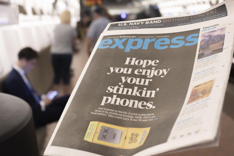 A final copy of the free commuter paper, Express, is seen at McPherson Square Metro Station in downtown Washington, Thursday, Sept. 12, 2019. The Washington Post announced yesterday that it has decided to cease publication of its Express commuter paper, that has been handed out for free at Metro stations for 16 years. (AP Photo/Pablo Martinez Monsivais)