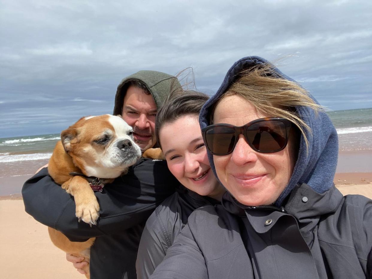 John Dow, shown with Lola and his daughter Sophie and wife Marley McDonald-Dow, says the Valley bulldog was part of the family. (Submitted by Marley McDonald-Dow - image credit)