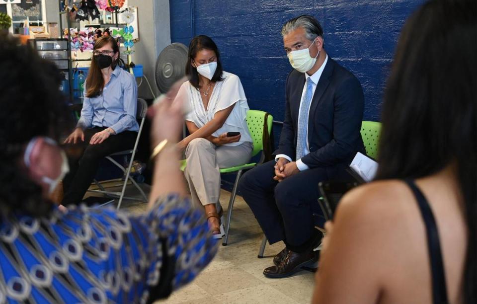California Attorney General Rob Bonta, right, listens to Rocio Madrigal from Central California Environmental Justice Network, bottom left, about environmental issues as Bonta met local Fresno County organizations and community leaders Tuesday, Aug. 9, 2022 in Fresno.