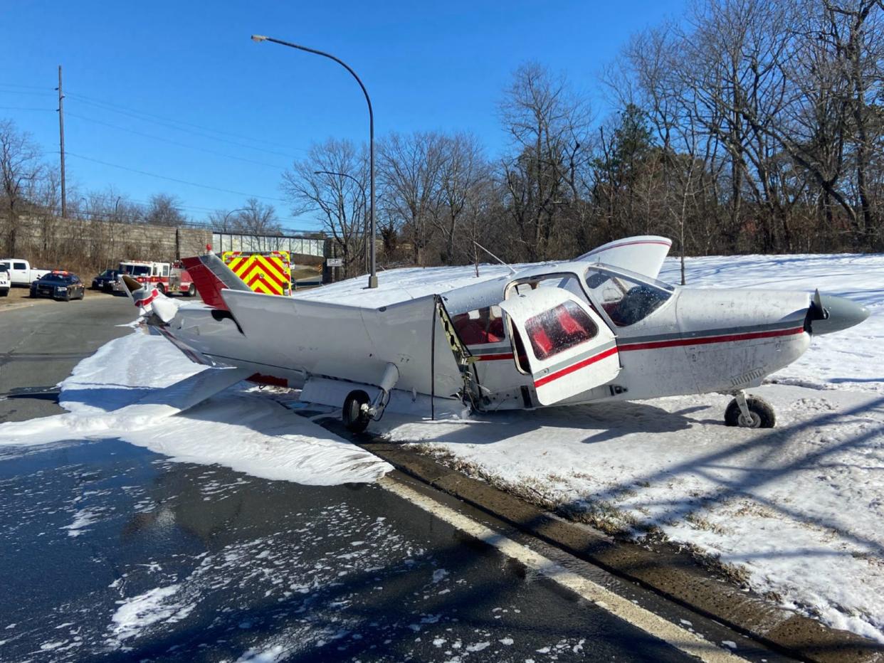 A single-engine Piper sits on the side of the Southern State Parkway in Farmingdale, New York, on Feb. 20, 2024 after an emergency landing. A National Transportation Safety Board report blames both the student pilot and the instructor for the incident.