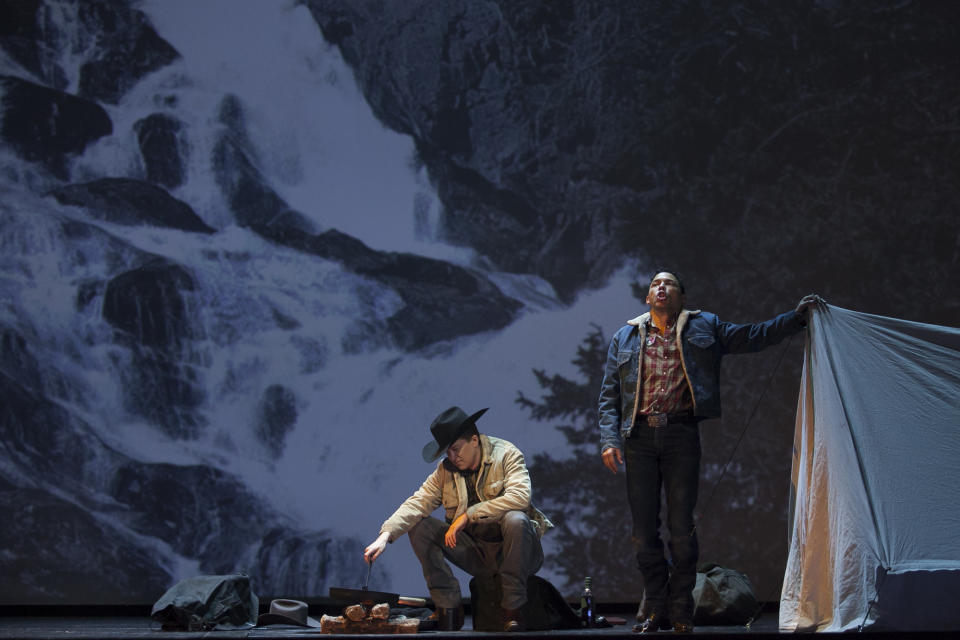 In this photo taken on Friday, Jan. 24, 2014, American tenor Tom Randle (Jack Twist), right, and Canadian bass-baritone Daniel Okulitch (Ennis del Mar), left, perform during the press rehearsal of the production "Brokeback Mountain" at the Teatro Real, in Madrid, Spain. It was a short story, then a Hollywood movie. Now the tragic tale of cowboys in love is being reinvented again: Brokeback Mountain _ the opera. Ahead of its world premiere in Madrid, author Annie Proulx told The Associated Press that the form of opera presented an opportunity to explore the complexities of the tale in a way neither her own short story nor the movie by director Ang Lee were able to do. (AP Photo/Gabriel Pecot)