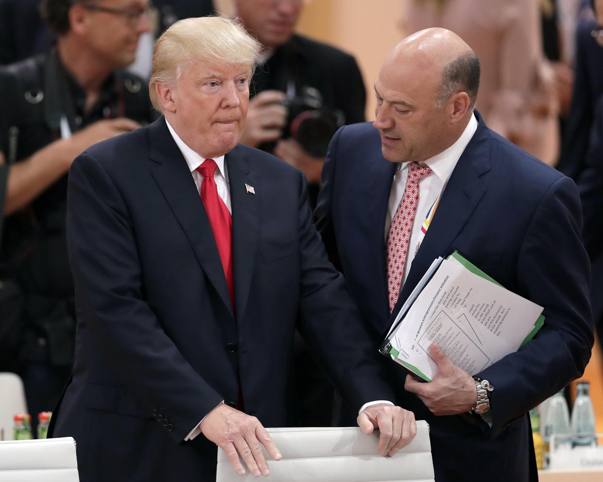 FILE – In this Saturday, July 8, 2017, file photo, White House chief economic adviser Gary Cohn, right, talks to U.S. President Donald Trump prior to a working session at the G-20 summit in Hamburg, Germany. Trump and his Republican partners in a nearly $6 trillion tax-cutting plan insist it would benefit middle-class Americans and not the wealthy. But a key provision of the plan would slash tax rates for a special kind of business set up by owners of profitable firms, including Trump and his family. (AP Photo/Michael Sohn, File)