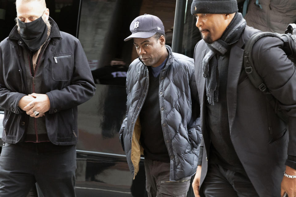 Chris Rock, center, arrives at the Wilbur Theater before a performance, Wednesday, March 30, 2022, in Boston. (AP Photo/Michael Dwyer)