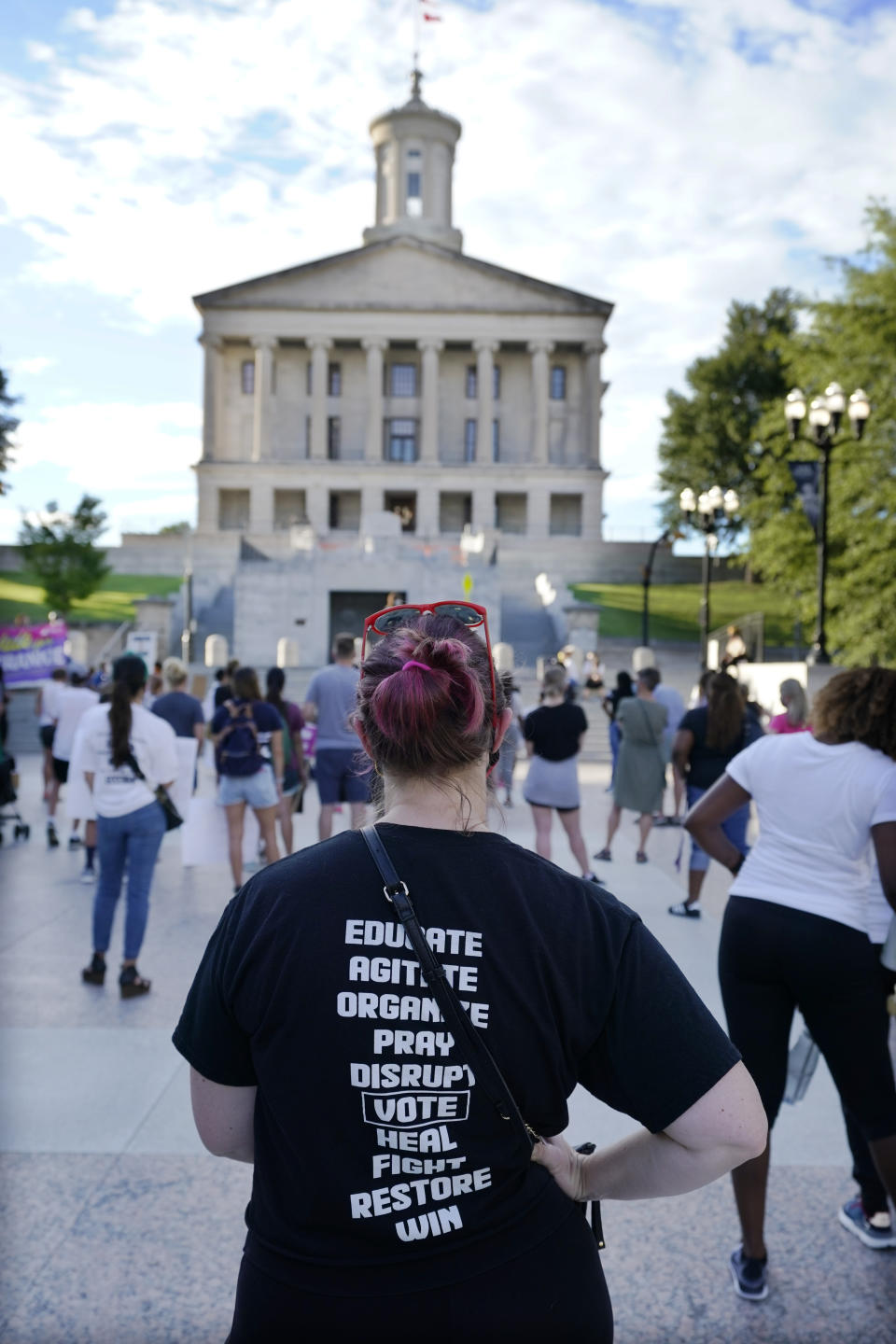 People demonstrate for voting rights across the street from the state capitol on Wednesday Aug. 26, 2020, in Nashville, Tenn. Tennessee's newest law, a wide range of crimes commonly associated with protests will see a big bump in penalties and fines, but the most contentious element focuses on escalated penalties for "illegal camping" on state property from a misdemeanor to a felony, punishable by up to six years in prison. The change has alarmed advocates, who point out that felony convictions in Tennessee result in the revocation of an individual's right to vote. (AP Photo/Mark Humphrey)