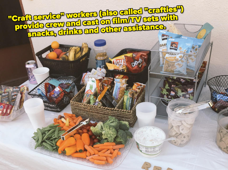 Assorted snacks on a table with vegetables, dips, chips, and energy bars