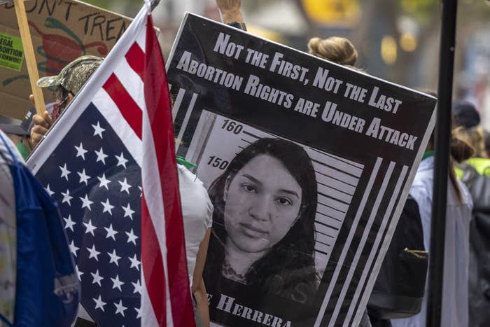 A photo of Lizelle Herrera is carried during a protest in Santa Monica, California, on July 16, 2022.