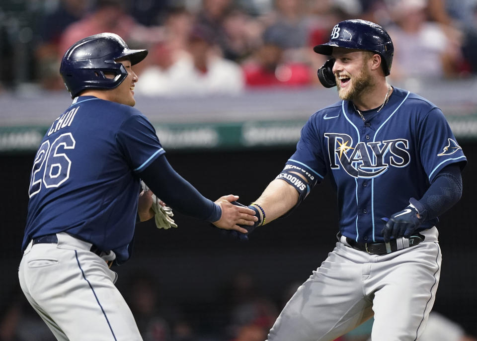 Tampa Bay Rays' Austin Meadows, right, is congratulated by Ji-Man Choi after Meadows hit a two-run home run in the ninth inning of the team's baseball game against the Cleveland Indians, Saturday, July 24, 2021, in Cleveland. (AP Photo/Tony Dejak)