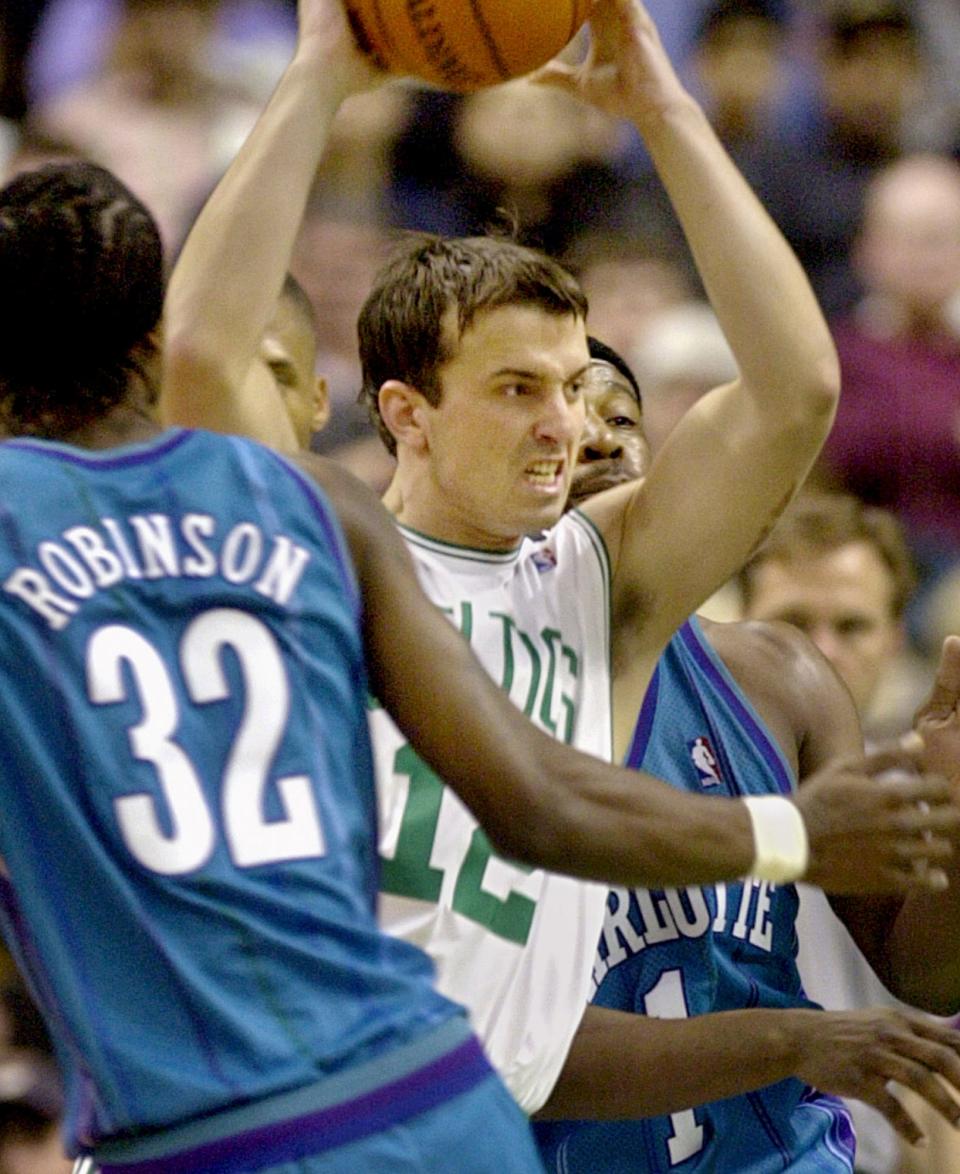 Boston Celtics' Chris Herren tries to keep the ball away from Charlotte defenders in a 2001 game.