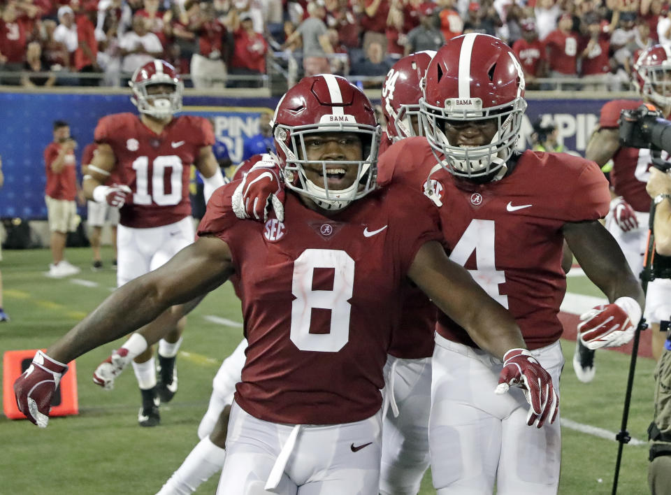 Alabama's Josh Jacobs (8) celebrates his touchdown run against Louisville with teammates, including wide receiver Jerry Jeudy (4), during the second half of an NCAA college football game Saturday, Sept. 1, 2018, in Orlando, Fla. (AP Photo/John Raoux)